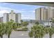 Scenic view from a balcony overlooking palm trees, city buildings, and a glimpse of the ocean at 5407 N Ocean Blvd., Myrtle Beach, SC 29577