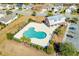 Aerial view features community pool, surrounded by houses and green landscaping at 5621 Camilla Ct., Myrtle Beach, SC 29579