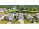 Aerial showcases community homes near pond, greenery, and mature trees at 5621 Camilla Ct., Myrtle Beach, SC 29579
