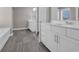Bright bathroom featuring a double vanity with modern fixtures, sleek tile flooring, and a separate tub at 5621 Camilla Ct., Myrtle Beach, SC 29579