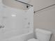 Bathroom showcasing a bathtub with a shower head, a toilet, and a towel rack on the wall at 5621 Camilla Ct., Myrtle Beach, SC 29579