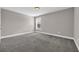 Cozy bedroom with plush carpeting, a window for natural light, and neutral wall paint at 5621 Camilla Ct., Myrtle Beach, SC 29579
