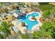 Aerial view shows community pool area with chairs, umbrellas, and building at 5621 Camilla Ct., Myrtle Beach, SC 29579