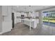 Modern kitchen featuring white cabinetry, an island, and a sliding glass door to the backyard at 5621 Camilla Ct., Myrtle Beach, SC 29579