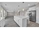 Bright, open-concept kitchen with large island, stainless steel appliances, and tile flooring at 5621 Camilla Ct., Myrtle Beach, SC 29579