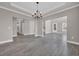 Open-concept living area with modern tile floors, chandelier, and seamless flow to other rooms at 5621 Camilla Ct., Myrtle Beach, SC 29579