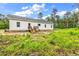 Exterior of a home with minimal landscaping and a small deck at the rear at 565 Kent Rd., Georgetown, SC 29440