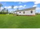 Exterior of a home with minimal landscaping and a small deck at the rear at 565 Kent Rd., Georgetown, SC 29440