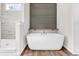 Serene bathroom featuring a standalone tub and a glass-enclosed shower, creating a spa-like ambiance with modern fixtures at 565 Kent Rd., Georgetown, SC 29440