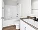 Bright bathroom featuring wood-look floors, a white vanity, and a shower-tub combination at 565 Kent Rd., Georgetown, SC 29440