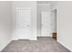 Bright bedroom featuring neutral walls, plush carpeting, and white paneled doors for a clean, modern aesthetic at 565 Kent Rd., Georgetown, SC 29440