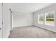 Spacious bedroom filled with natural light from large windows, complemented by neutral walls and soft carpeting at 565 Kent Rd., Georgetown, SC 29440