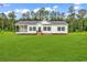 Charming single-story home with a covered porch and a large, well-manicured lawn at 565 Kent Rd., Georgetown, SC 29440