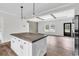 Modern kitchen with wood-look floors, island with wooden countertop, and pendant lighting at 565 Kent Rd., Georgetown, SC 29440