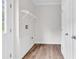 Bright laundry room featuring white walls, wood-look floors, and a wire shelf at 565 Kent Rd., Georgetown, SC 29440