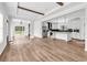 Open floor plan features bright living room, recessed lighting, wood-look flooring, and access to kitchen and deck at 565 Kent Rd., Georgetown, SC 29440