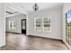 Living room with wood-look floors, white walls, and natural light from many windows at 565 Kent Rd., Georgetown, SC 29440