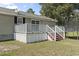 Cozy back deck with white railings and stairs leading to a spacious lawn and trampoline at 568 Rosedale Dr., Aynor, SC 29511