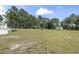 Expansive backyard featuring a level lawn, outbuildings, and mature trees at 568 Rosedale Dr., Aynor, SC 29511