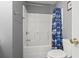 Bathroom featuring shower-tub combo with blue shower curtain and white toilet at 568 Rosedale Dr., Aynor, SC 29511