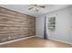 Bedroom with feature wood wall, hardwood floors, and window at 568 Rosedale Dr., Aynor, SC 29511