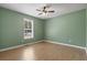 Bedroom featuring green walls, wood-look floors, and large window at 568 Rosedale Dr., Aynor, SC 29511