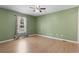 Empty bedroom with laminate floor, neutral window treatments and a light green painted walls at 568 Rosedale Dr., Aynor, SC 29511