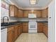 Well-lit kitchen with tile floor, cabinets, white appliances, and overhead lighting at 568 Rosedale Dr., Aynor, SC 29511