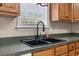 Close up of a large double sink basin with black faucet and green countertops at 568 Rosedale Dr., Aynor, SC 29511