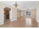 Open-concept living room with hardwood floors, chandelier, and view into the kitchen at 568 Rosedale Dr., Aynor, SC 29511