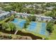 Aerial view of tennis and pickleball courts nestled within a community, enhancing recreational opportunities at 5905 S Kings Hwy. # 242B, Myrtle Beach, SC 29575
