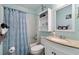 Well-lit bathroom with vanity, toilet, and shower with a shower curtain at 5905 S Kings Hwy. # 242B, Myrtle Beach, SC 29575