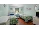 Comfortable bedroom with two beds, wood floors, and coastal decor at 5905 S Kings Hwy. # 242B, Myrtle Beach, SC 29575