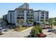 Beautiful condo building with ocean view, mature landscaping, and ample parking at 5905 S Kings Hwy. # 242B, Myrtle Beach, SC 29575