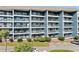 Apartment building featuring multiple balconies and lush landscaping, highlighting comfortable outdoor living spaces at 5905 S Kings Hwy. # 242B, Myrtle Beach, SC 29575