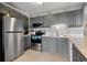 Modern kitchen features stainless steel appliances and gray cabinetry at 5905 S Kings Hwy. # 242B, Myrtle Beach, SC 29575