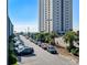 View of parking along a waterway, palm trees, and the beach tower at 5905 S Kings Hwy. # 242B, Myrtle Beach, SC 29575