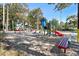 A charming playground with colorful slides, and benches surrounded by trees, perfect for outdoor activities at 5905 S Kings Hwy. # 242B, Myrtle Beach, SC 29575