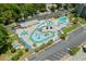 Aerial view of a waterpark with a lazy river, pools, and lounge chairs, ideal for summer fun and relaxation at 5905 S Kings Hwy. # 242B, Myrtle Beach, SC 29575