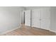 Neutral bedroom showcasing wood-look floors and a closet with doors at 600 Woodside Dr., Conway, SC 29526