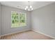 Dining area features hardwood floors, modern lighting fixture, and a large window at 600 Woodside Dr., Conway, SC 29526
