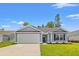 Charming one-story home with a well-manicured lawn, attached garage, and inviting entrance at 600 Woodside Dr., Conway, SC 29526
