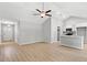 Open-concept living space with plank flooring, white kitchen, and bright natural light at 600 Woodside Dr., Conway, SC 29526