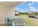 Comfortable balcony seating with blue patio furniture and views of the green courtyard at 604 Heathrow Dr. # 1101, Myrtle Beach, SC 29579