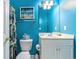 Bathroom with blue walls, tropical themed decor, vanity sink and toilet at 604 Heathrow Dr. # 1101, Myrtle Beach, SC 29579