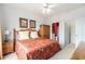 Bedroom showing the closet and bathroom access as well as wood furniture, a ceiling fan, and a window at 604 Heathrow Dr. # 1101, Myrtle Beach, SC 29579