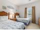 Bright bedroom features two twin beds, wood furniture, and charming beach-themed decor at 604 Heathrow Dr. # 1101, Myrtle Beach, SC 29579