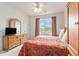 Bright bedroom with a ceiling fan, a large window with a view, and wood furniture at 604 Heathrow Dr. # 1101, Myrtle Beach, SC 29579