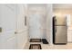Entryway of home with coat closet, stainless steel fridge, and neutral ceramic tile flooring at 604 Heathrow Dr. # 1101, Myrtle Beach, SC 29579
