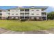 Well-maintained condo building featuring screened porches and manicured lawn at 604 Heathrow Dr. # 1101, Myrtle Beach, SC 29579